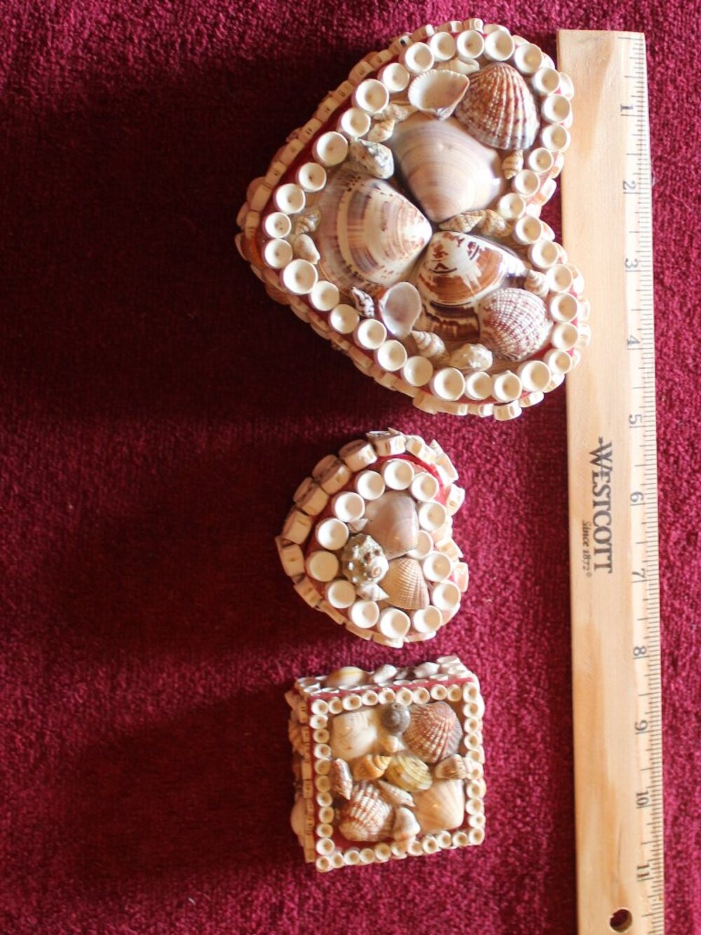 Vintage seashell-encrusted trinket boxes adorned with natural shells